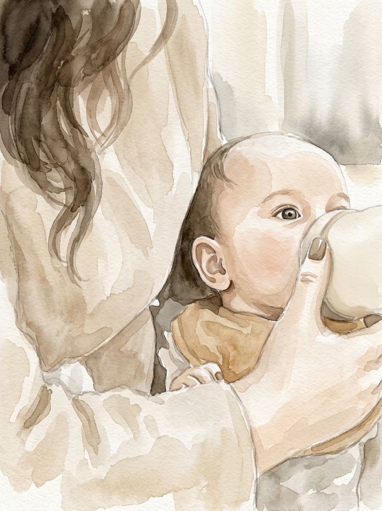 A baby drinking from a bottle in his mother’s arms